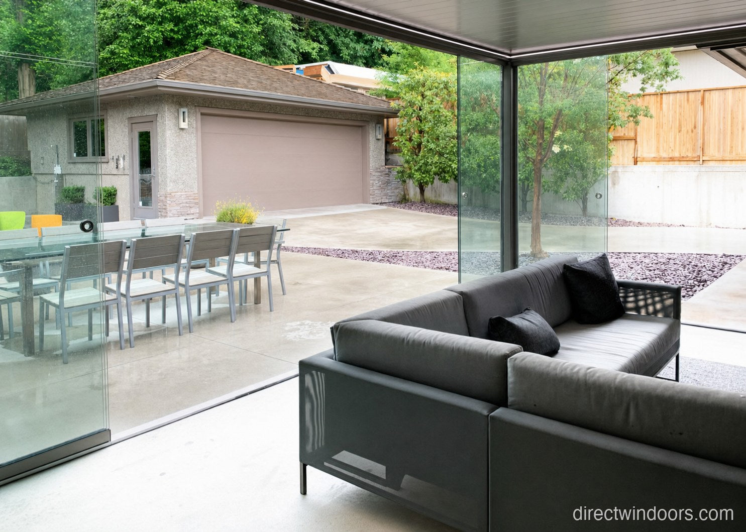 Frameless glass walls converting a garage into a living-room extension