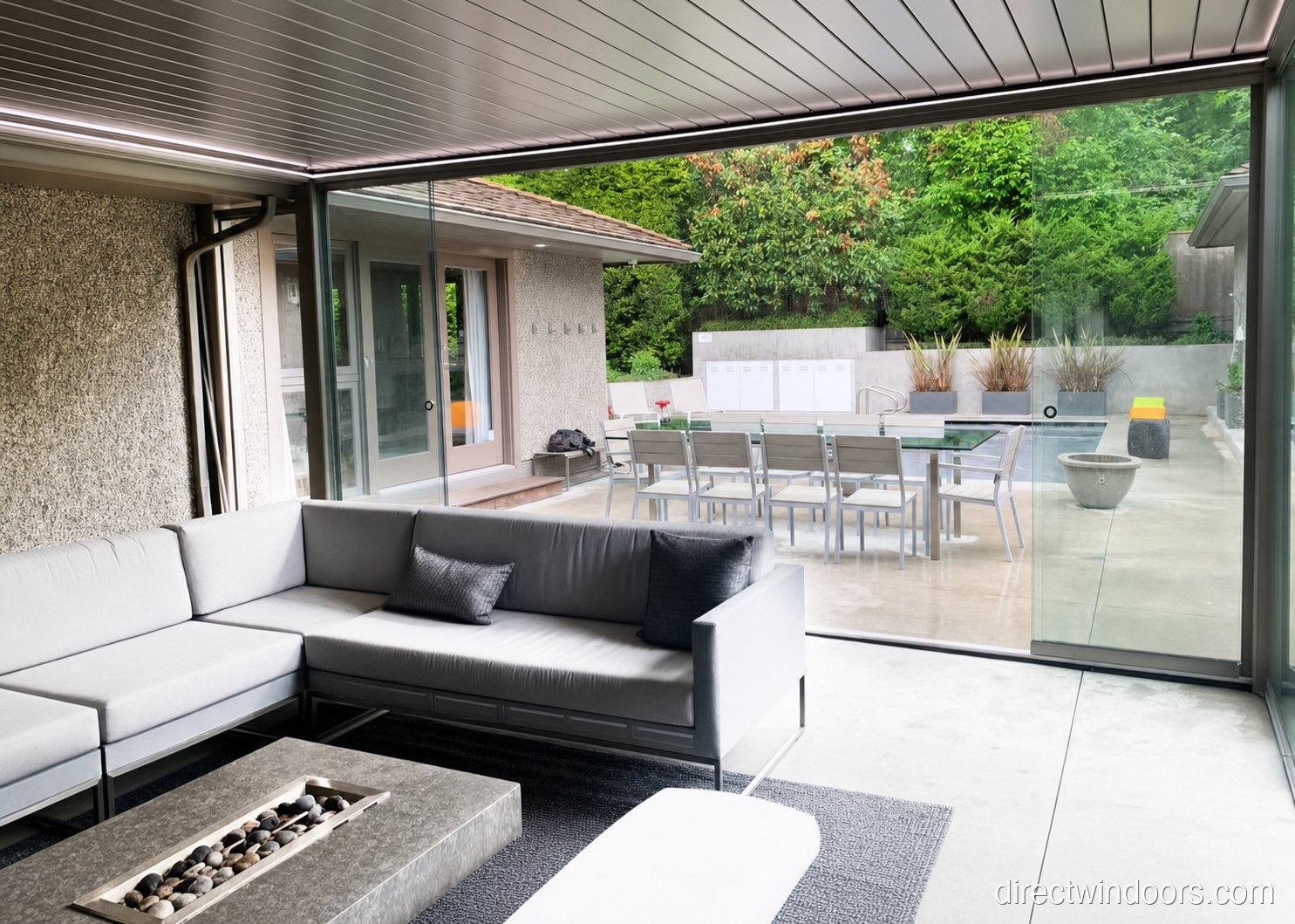 Frameless glass walls at a mountain-view pool deck